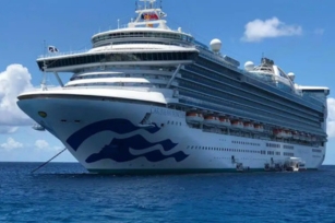 close up of the front of the Caribbean Princess cruise ship cruising through the calm clear seas