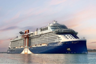 image of the Celebrity Ascent cruise ship cruising along the calm waters featuring the red hue in the skies