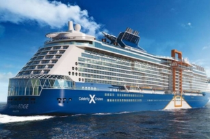 close up of the Celebrity Edge cruise ship cruising through the deep blue water.
