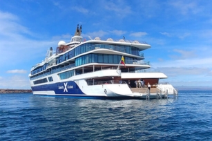 image of the Celebrity Flora cruise ship featuring the deep blue seas and blue skies