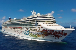 closeup of the Norwegian Gem showing its vibrant colours as the cruise glides through the dark blue seas
