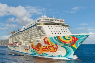 A the vibrant Norwegian Getaway cruise ship gliding through the calm sea on a sunny day 