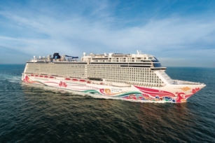 image of Norwegian Joy featuring colourful base gliding through deep blue waters