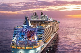 view of the back of the cruise line Oasis of the Seas against a red sky