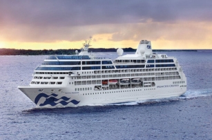 Image of Pacific Princess cruising through the waters featuring the cloudy skies