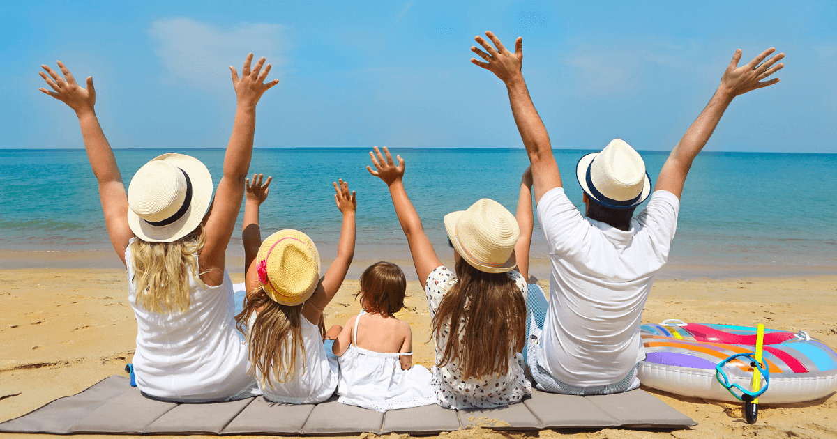 A family sitting on the beach.